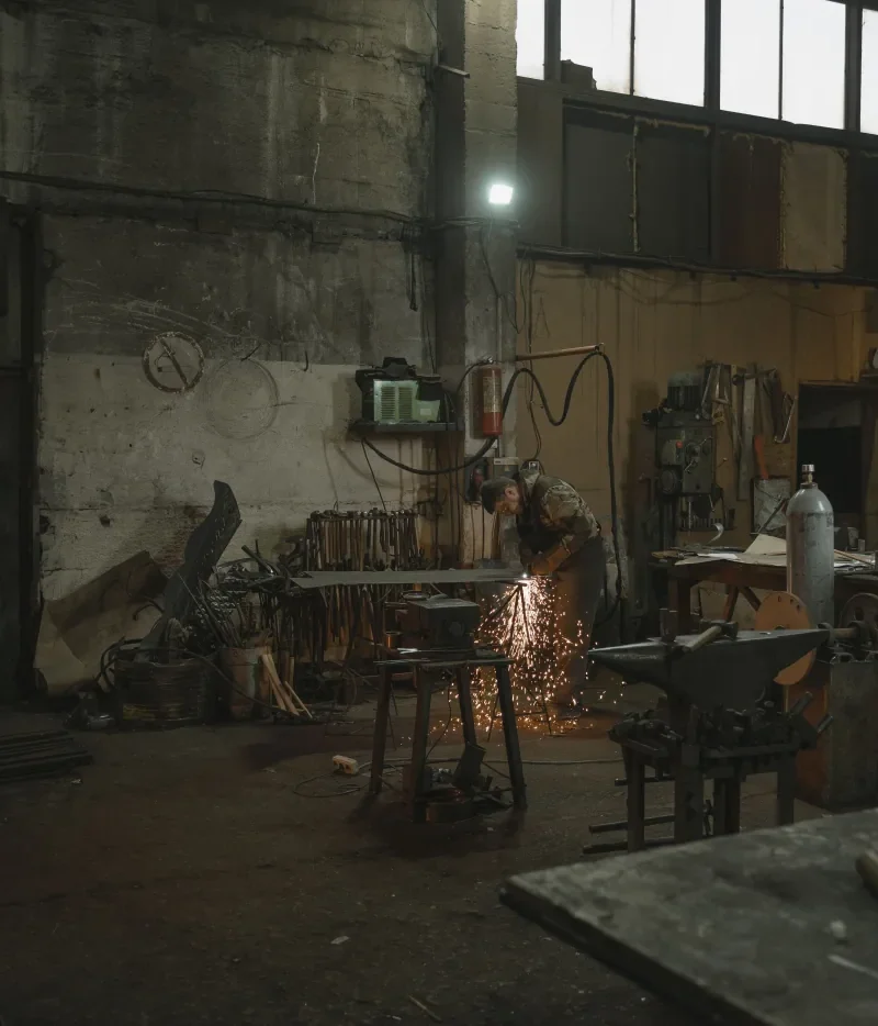 Industrial welder working on a metal component; Pexels photo by Tima Miroshnichenko.